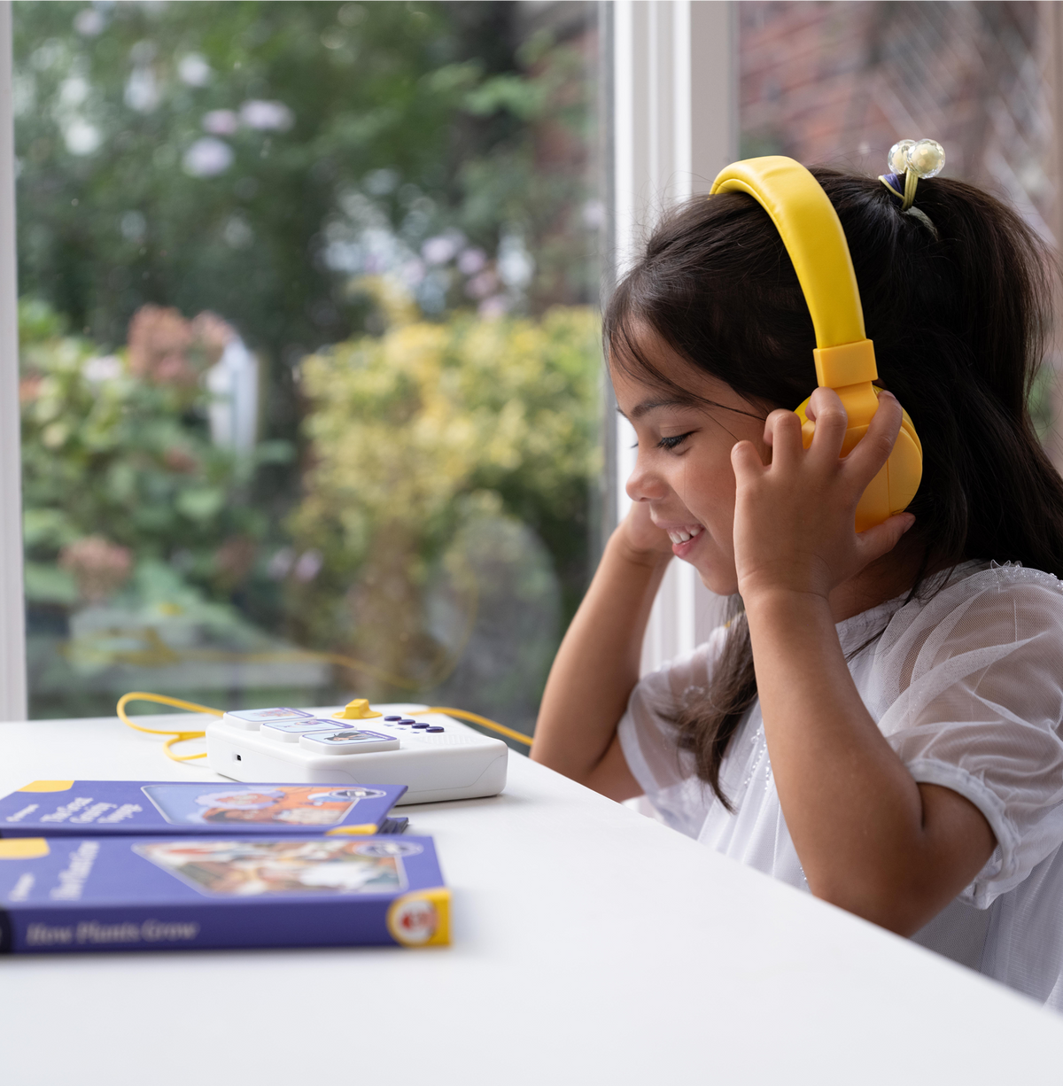 Child building a story with blocks on the storymaker screen-free storytelling toy