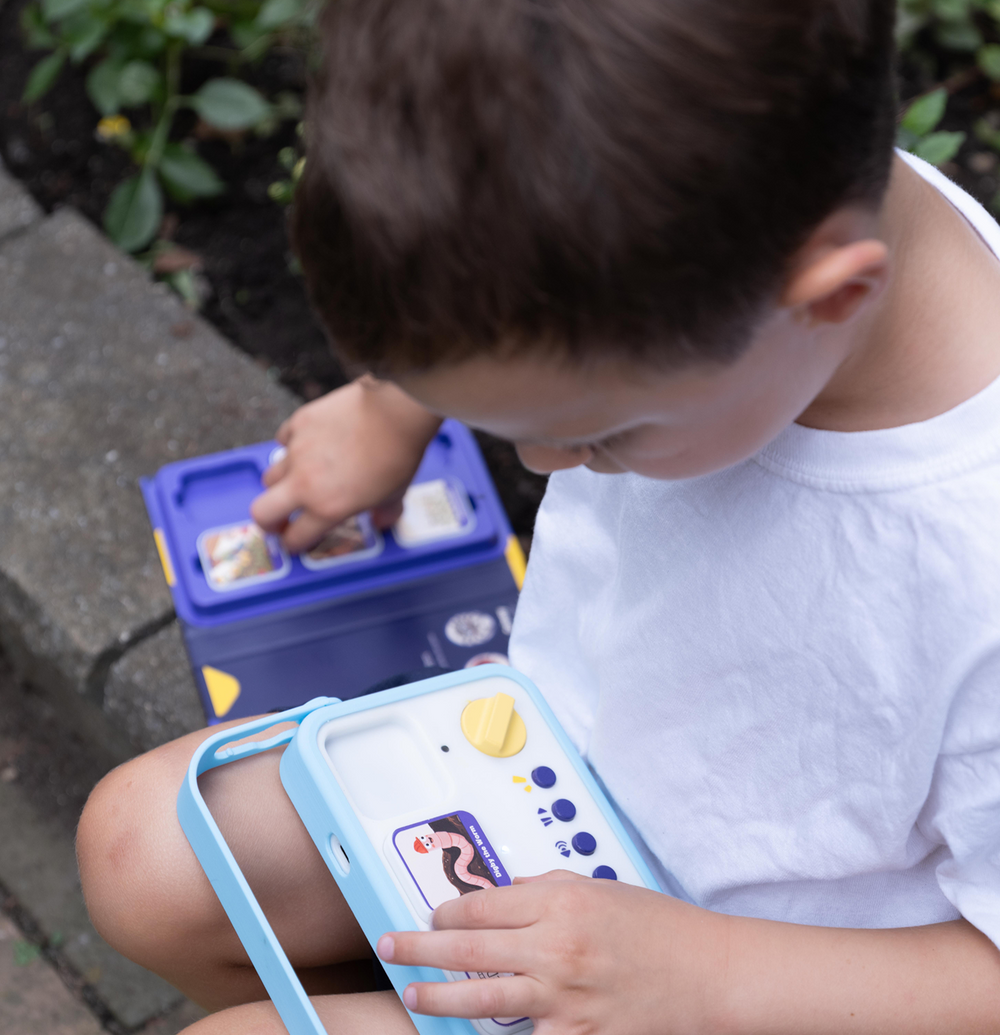 Child placing story blocks on the storymaker storytelling toy