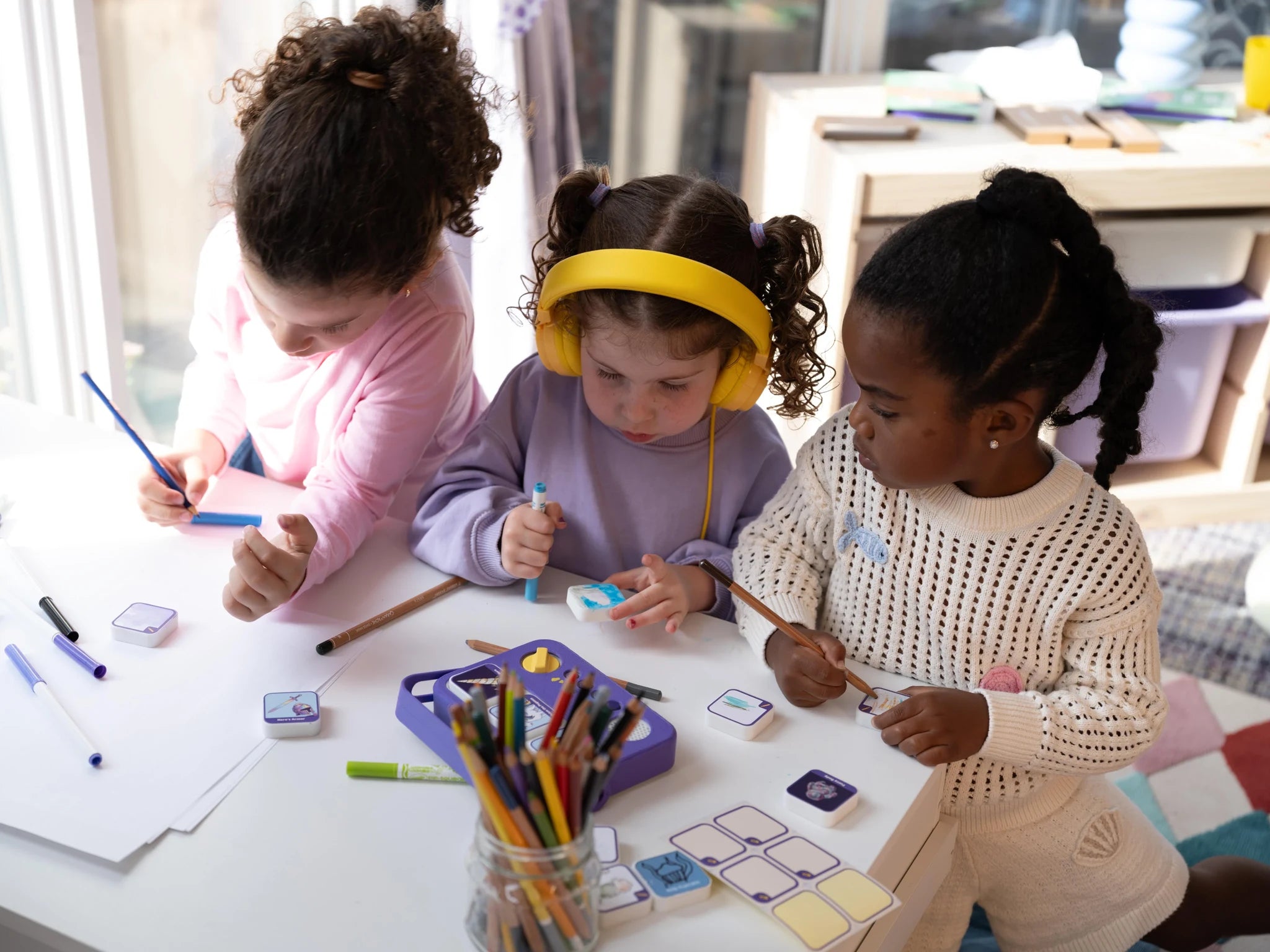 Children drawing their own story blocks together.